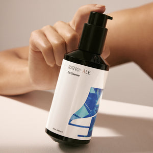 #4 The Cleanser 200ml formulation bottle held by model.